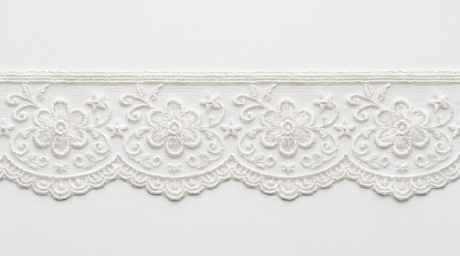 Elegant white lace trim featuring delicate floral embroidery patterns displayed in a high resolution photograph that captures the intricate details and texture of the fabric material