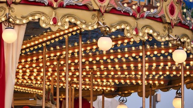 Carousel lights glowing, vintage amusement park ride with decorative details