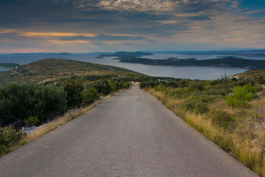 Beauty way to the sea, exotic islands, amazing clouds and sea in the sunset near Primosten, Dalmatia, Croatia