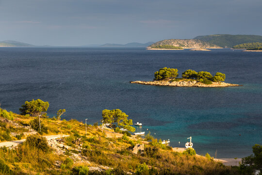 Cozy mediterranean island. Blue lagoon, island paradise. Adriatic Sea of Croatia, popular touristic destination near Primosten. Clear sea water.