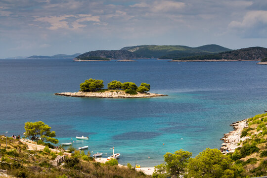 Cozy mediterranean island. Blue lagoon, island paradise. Adriatic Sea of Croatia, popular touristic destination near Primosten. Clear sea water.