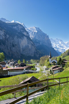 Amazing view of the picturesque alpine town of Lauterbrunnen, Switzerland. The village church and the Staubbach Falls in Lauterbrunnen