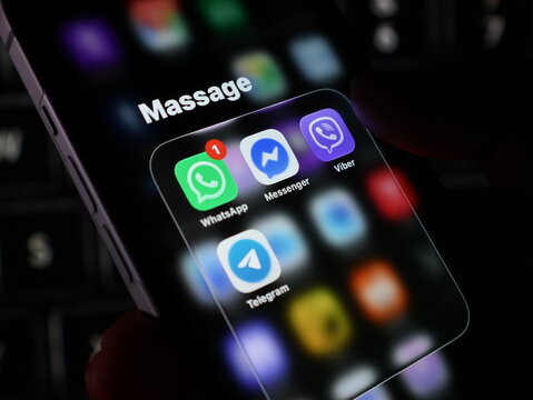 Closeup of a smartphone screen displaying popular messaging apps like whatsapp, messenger, viber, and telegram in a folder named massage