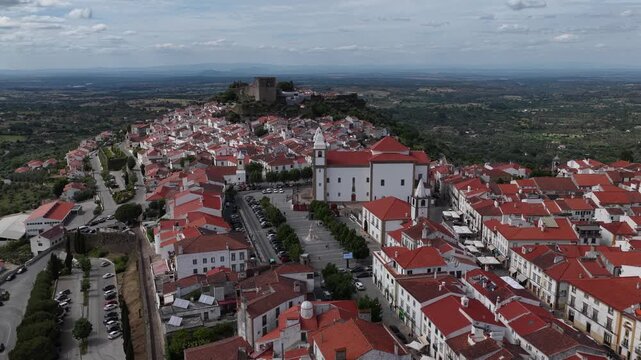 Aerial view of Castle of Castelo de Vide with white houses and red-tiled roofs under a cloudy sky in Castelo de Vide, Portalegre, Portugal.