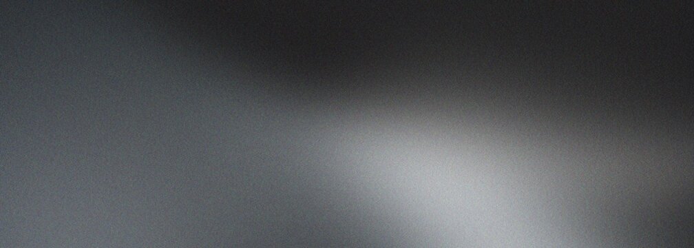 Abstract gray grain background with soft white light and subtle noise texture, creating a smooth and atmospheric monochrome gradient.