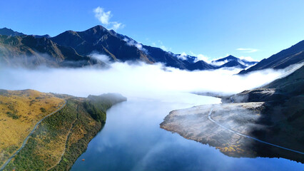 Fototapeta premium Aerial View of Fog Rolling Over Moke Lake in Queenstown New Zealand