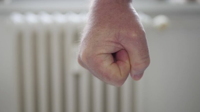 Shooting with an Angry Man Clenching the Fist in Sign of Protest. One Person Getting Mad and Clench the Hand Fingers in a Fist.