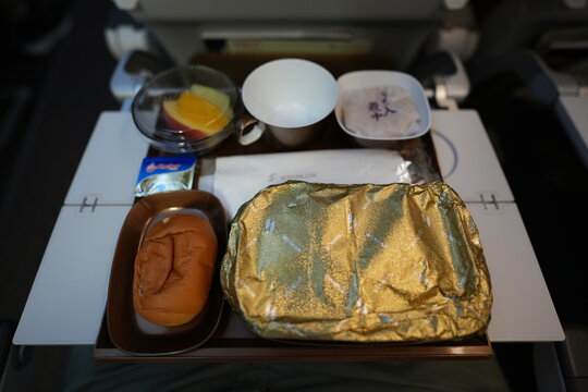 Inflight meal tray served on an airplane economy class seat table.