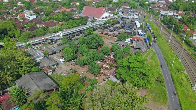 Aerial view of Animal Market Prambanan with railway tracks and urban rooftops in Kecamatan Prambanan, Jawa Tengah, Indonesia.