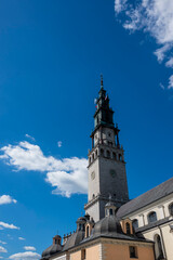 Obraz premium facade of Jasna Gora Monastery in Czestochowa, Poland, set against a bright blue sky.