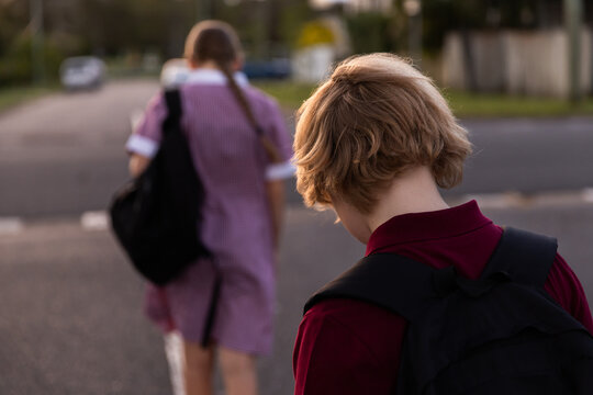 kids in school uniform trudging home with heads down