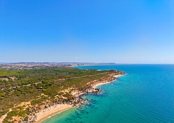 Naklejka premium aerial view of the cliffs along the Atlantic coast between Conil de la Frontera and Roche, Calas de Roche, Calas de Conil, Cala el Frailecillo, Cabo Roche, Proyecto Limes Marinas, Andalusia, Spain