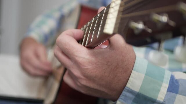 Blurred Shooting with a Musician Playing on Guitar, Relaxing with Music. Senior Artist Playing a Song on Classic Wooden Guitar.