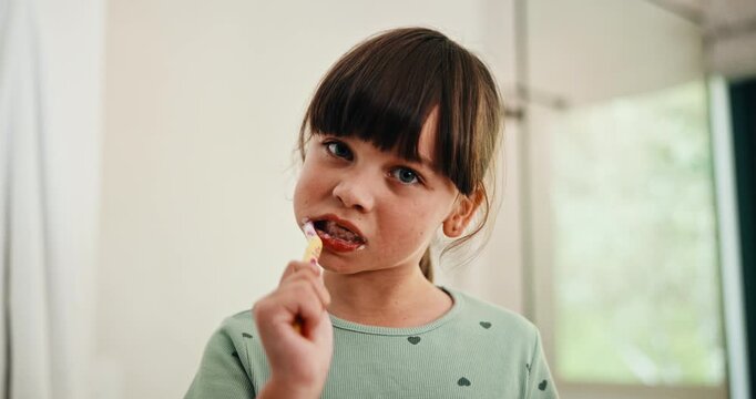 Bathroom, face and girl with toothbrush, brushing teeth or cavity prevention with toothpaste in home. Clean, mouth and child with dental care equipment for fresh breath, portrait and hygiene in house