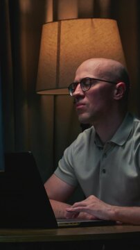 Portrait: Man stock trader in home office. Male analyzes terminal, trades stocks on crypto market. Quotes from Bitcoin Ethereum, or funds. Candlestick or trading charts, price action on laptop screen
