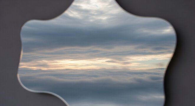 Cloudy sky reflection in an irregular mirror shape