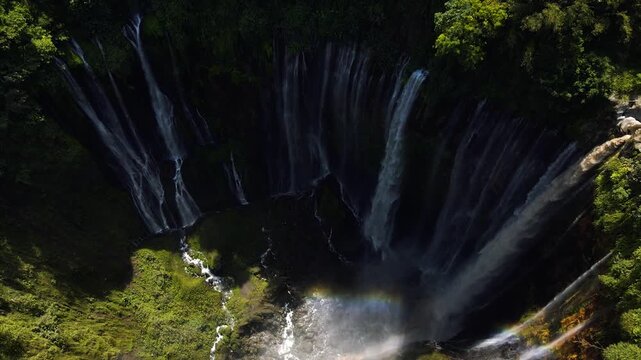 Stunning 4K aerial view of Tumpak Sewu waterfall curtains in East Java, Indonesia.