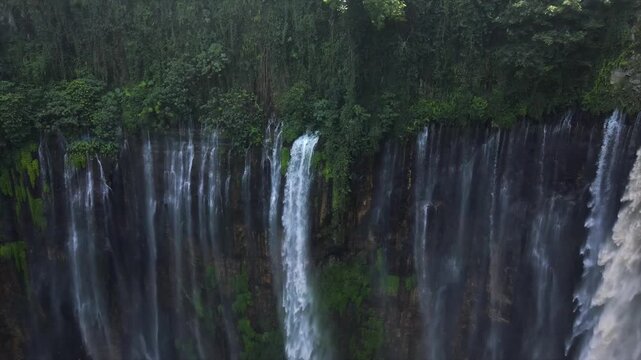 Stunning 4K aerial view of Tumpak Sewu waterfall curtains in East Java, Indonesia.