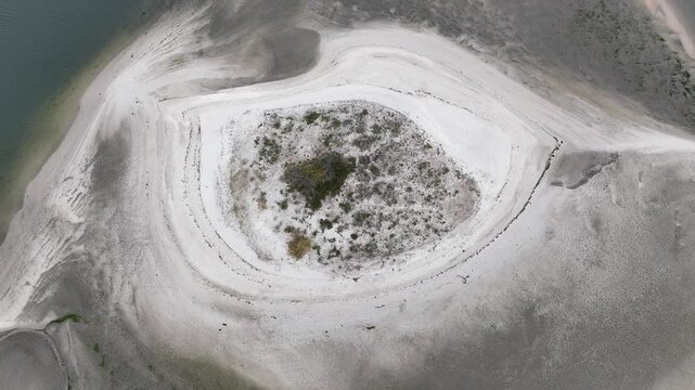 Aerial view of a small sandy island with sparse vegetation in the Aveiro Lagoon, Aveiro, Aveiro District, Portugal.