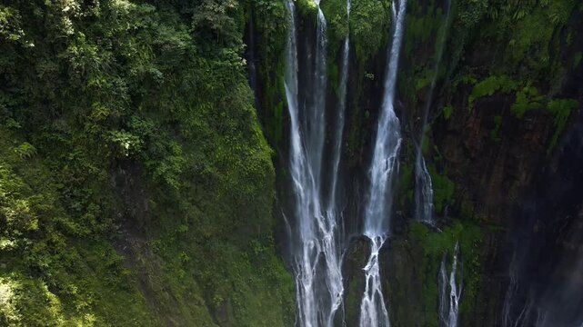Stunning 4K aerial view of Tumpak Sewu waterfall curtains in East Java, Indonesia.