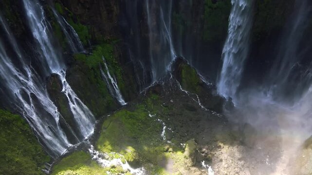 Stunning 4K aerial view of Tumpak Sewu waterfall curtains in East Java, Indonesia.