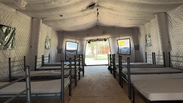 Humanitarian shelter tent prepared for overnight accommodation and temporary stay of people.