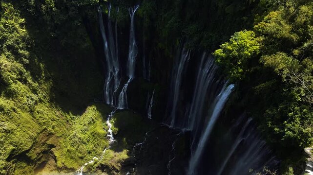 Stunning 4K aerial view of Tumpak Sewu waterfall curtains in East Java, Indonesia.