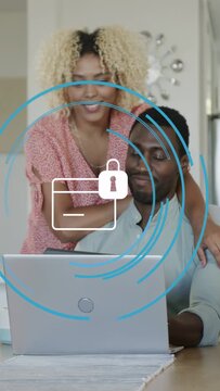 Vertical video: Couple leaning, man tapping laptop causing blue rings locked folder for security