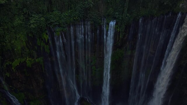 Stunning 4K aerial view of Tumpak Sewu waterfall curtains in East Java, Indonesia.