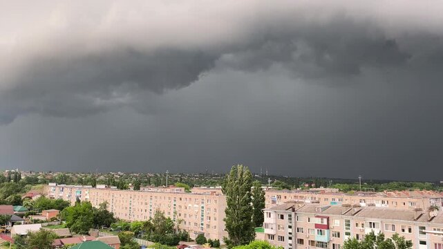 Dark stormy sky over city with lightning strikes and thunderclouds, summer storm approaching