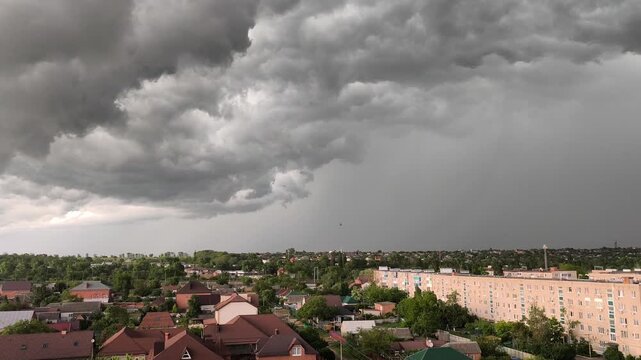 Dark stormy sky over city with lightning strikes and thunderclouds, summer storm approaching