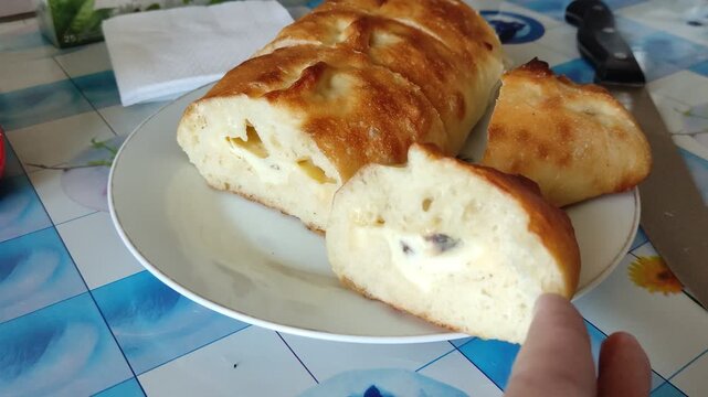 Person opening sliced loaf of bread with cheese and mold inside