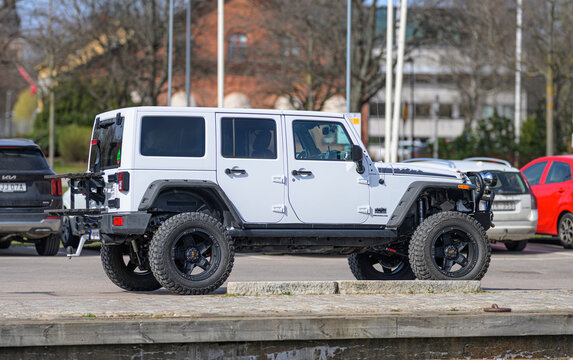 V?ster?s, Sweden - April 18 2026: White off road vehicle parked near waterfront with urban background and rugged lifestyle theme.