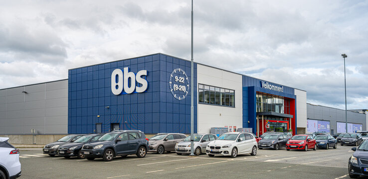 Gothenburg, Sweden - June 27 2023: Large OBS retail warehouse building with parking lot and cars.