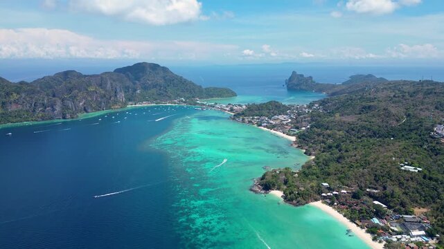 Phi Phi Island, Thailand : Aerial drone footage of white sand beach in Ko Phi Phi, famous island in Andaman sea of Thailand with turquoise water and white sand beach. Taken with tilt up motion