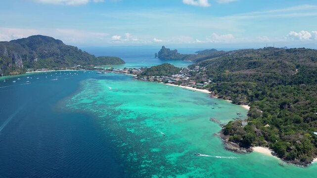 Phi Phi Island, Thailand : Aerial drone footage of the stunning Koh Phi Phi, famous island in Andaman sea of Thailand with turquoise water and white sand beach. Taken with a cinematic tilt up motion