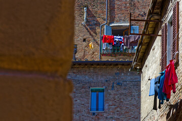 Fototapeta premium Some laundry is drying on the balconies of the houses of city center of Siena, Italy