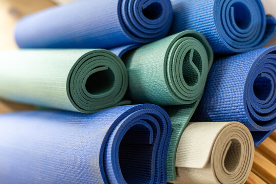 Colorful rolled yoga mats stack