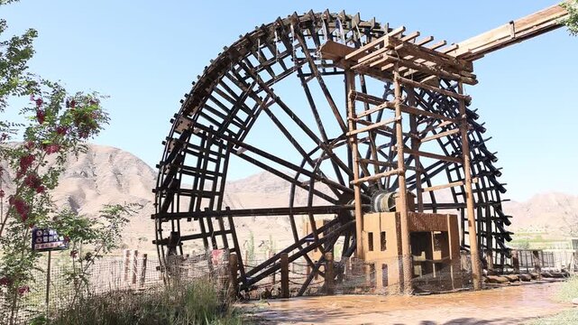 Ancient waterwheels operating on the Gobi Desert along the Yellow River in Beichangtan Yellow River Village, Zhongwei, Ningxia, China.