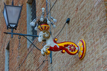 Fototapeta premium SIENA, ITALY, April 24, 2026 : Street colored ram decoration in the streets of old city