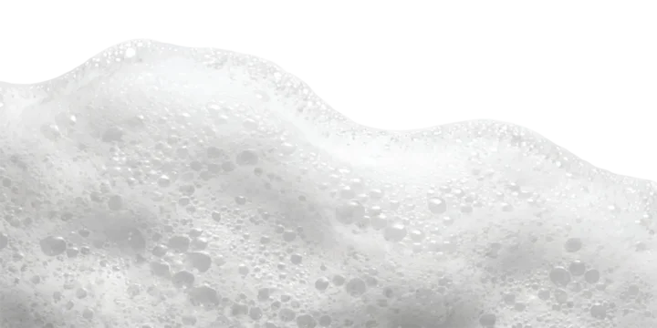 Soft white soap bubbles foam texture with round circles and water suds for cleaning and hygiene products background