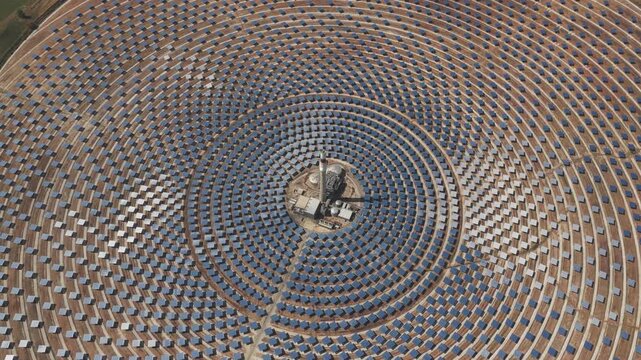 Aerial view of Torresol Energy Gemasolar solar power plant with concentric heliostat mirrors reflecting sunlight in Fuentes de Andalucia, Andalucia, Spain.