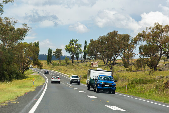 Car pulling caravan traveling along highway road going on holiday trip through Australia
