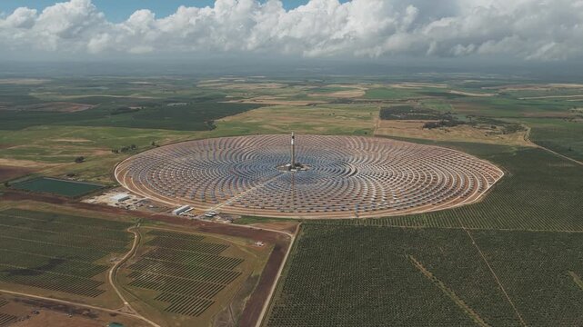 Aerial view of the Torresol Energy Gemasolar solar power plant with its central tower and circular heliostat field in Fuentes de Andalucia, Andalucia, Spain.