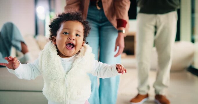 Face, baby and walk with support at house for first steps, balance guidance and proud moment. Portrait, parents and people with toddler for mobility, teaching coordination and milestone encouragement