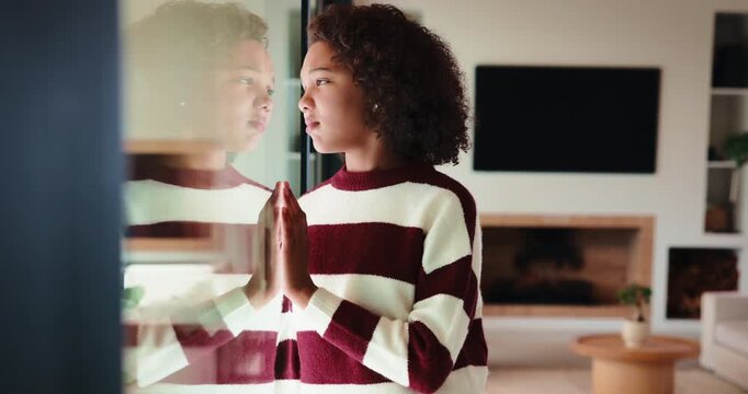 Window, thinking and child with depression in home, adoption crisis and loneliness with memory. Reflection, sad and unhappy girl with anxiety, thoughts and foster care trauma by glass in house