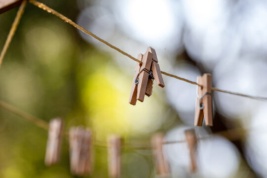 Old fashioned string clothes line with wooden pegs