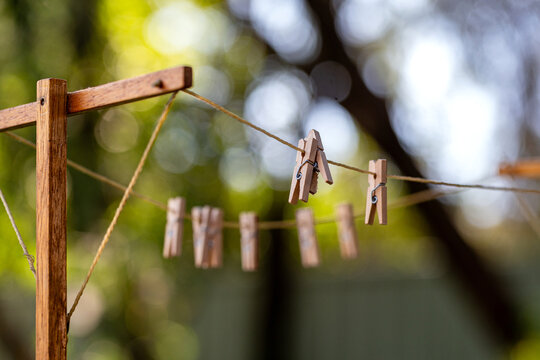 Old fashioned string clothes line with wooden pegs