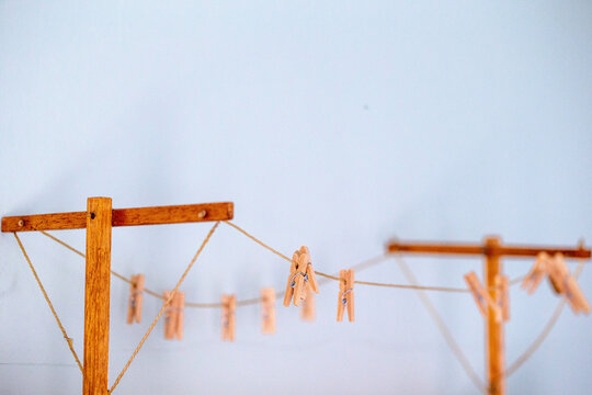 Old fashioned string clothes line with wooden pegs