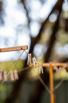 Old fashioned string clothes line with wooden pegs